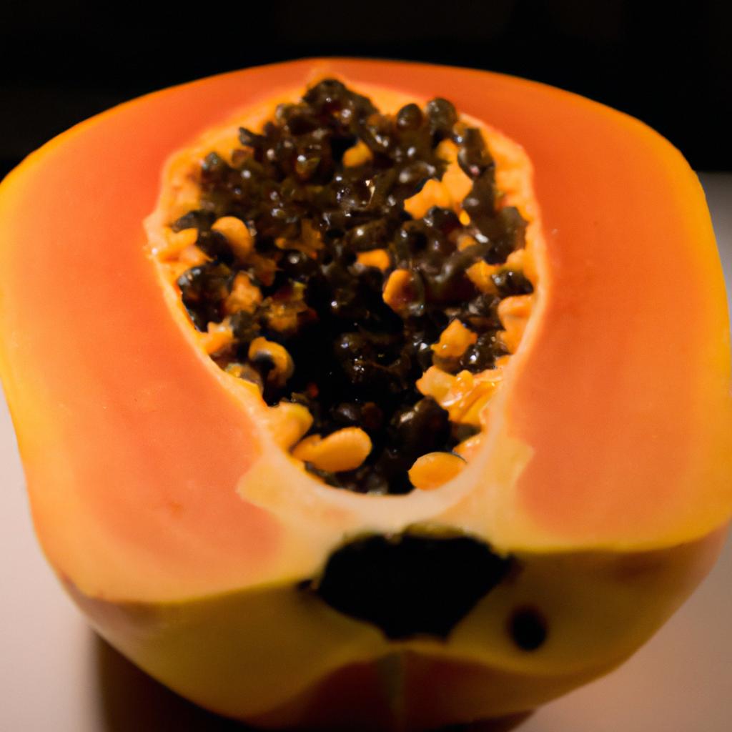 A ripe papaya cut open to show its juicy and sweet fruit inside.