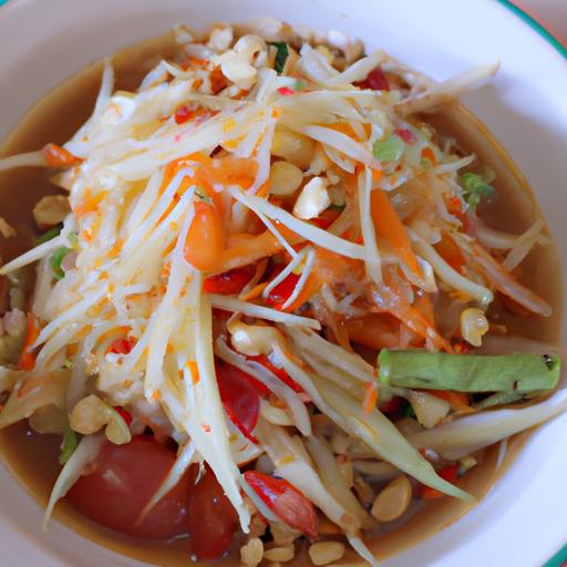 A delicious and healthy papaya salad with a mix of veggies, nuts, and dressing