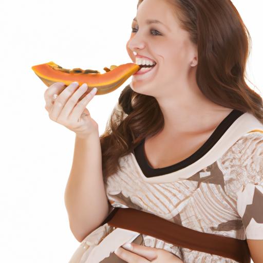 A woman indulges in a refreshing snack of papaya while pregnant.