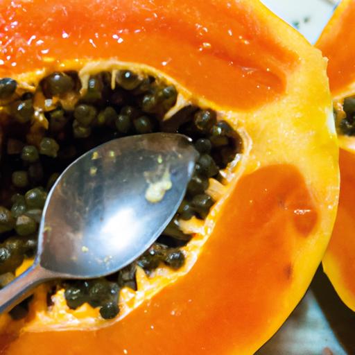 A ripe papaya cut in half, revealing its juicy and nutritious flesh