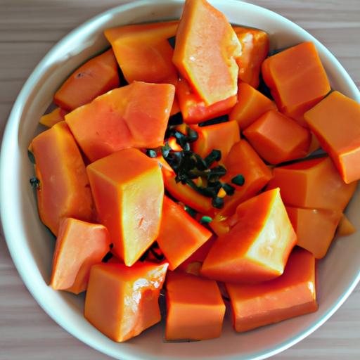 Sliced papaya fruit on a bowl with seeds.